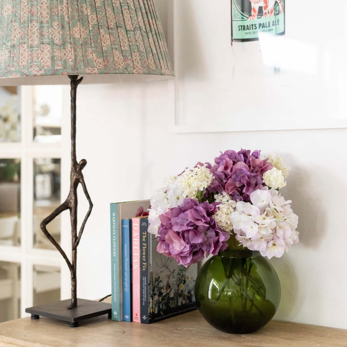 small arrangement of artificial purple flowers in vase