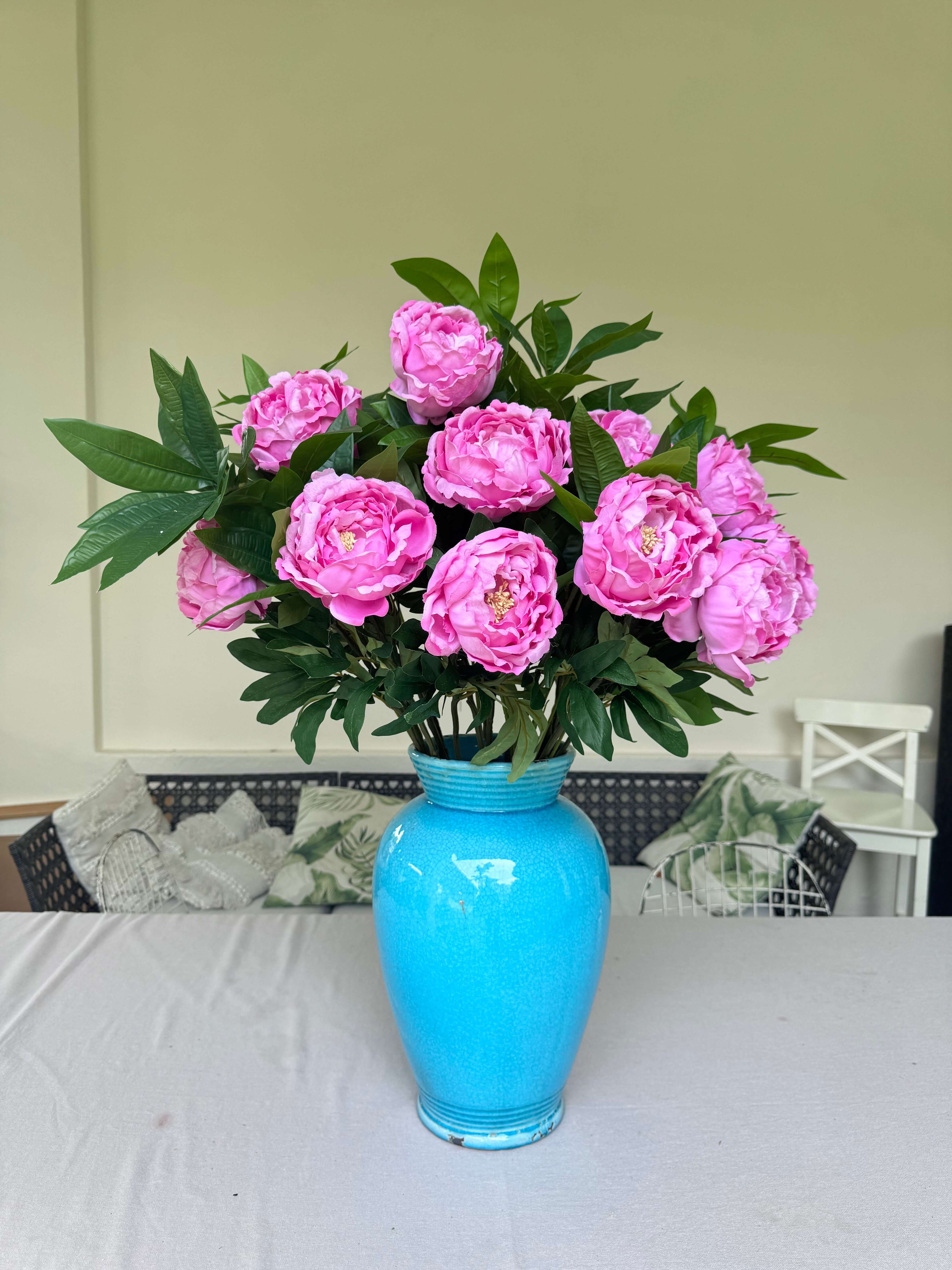 artificial pink flowers in a blue vase bespoke arrangement