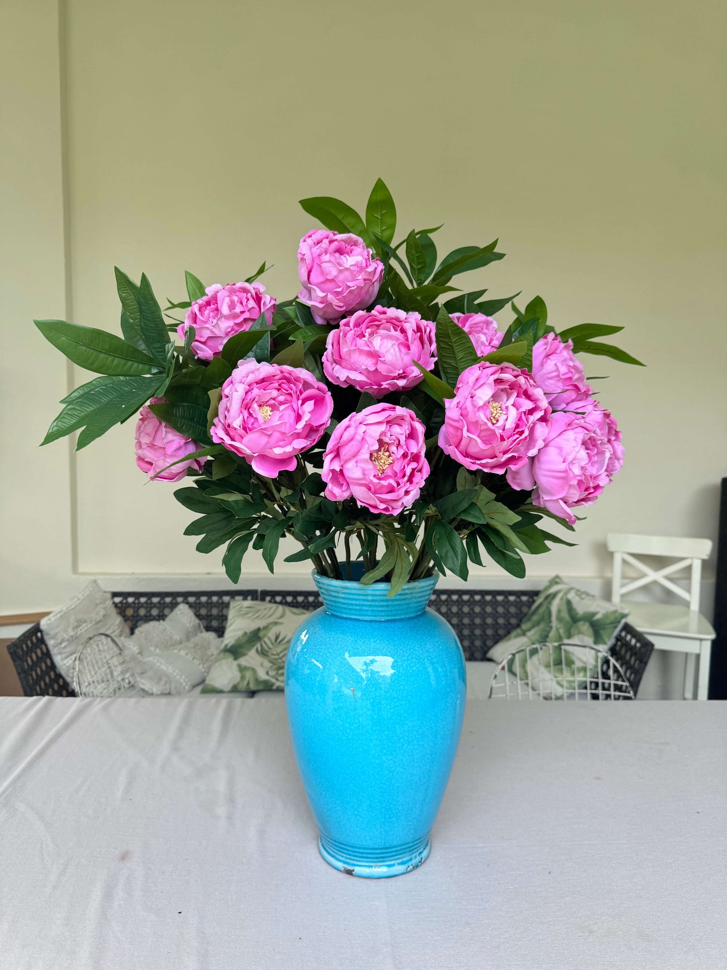 artificial pink flowers in a blue vase bespoke arrangement