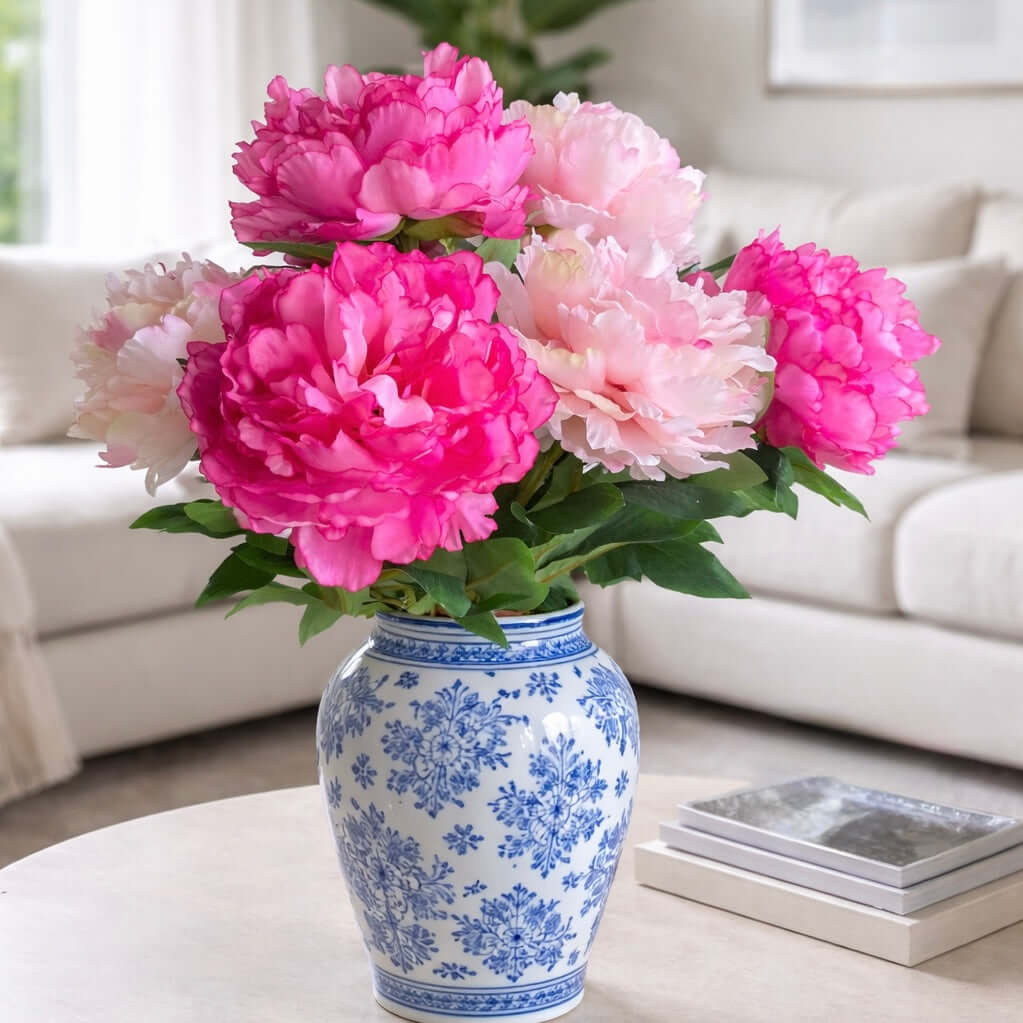 pink peonies in blue and white vase