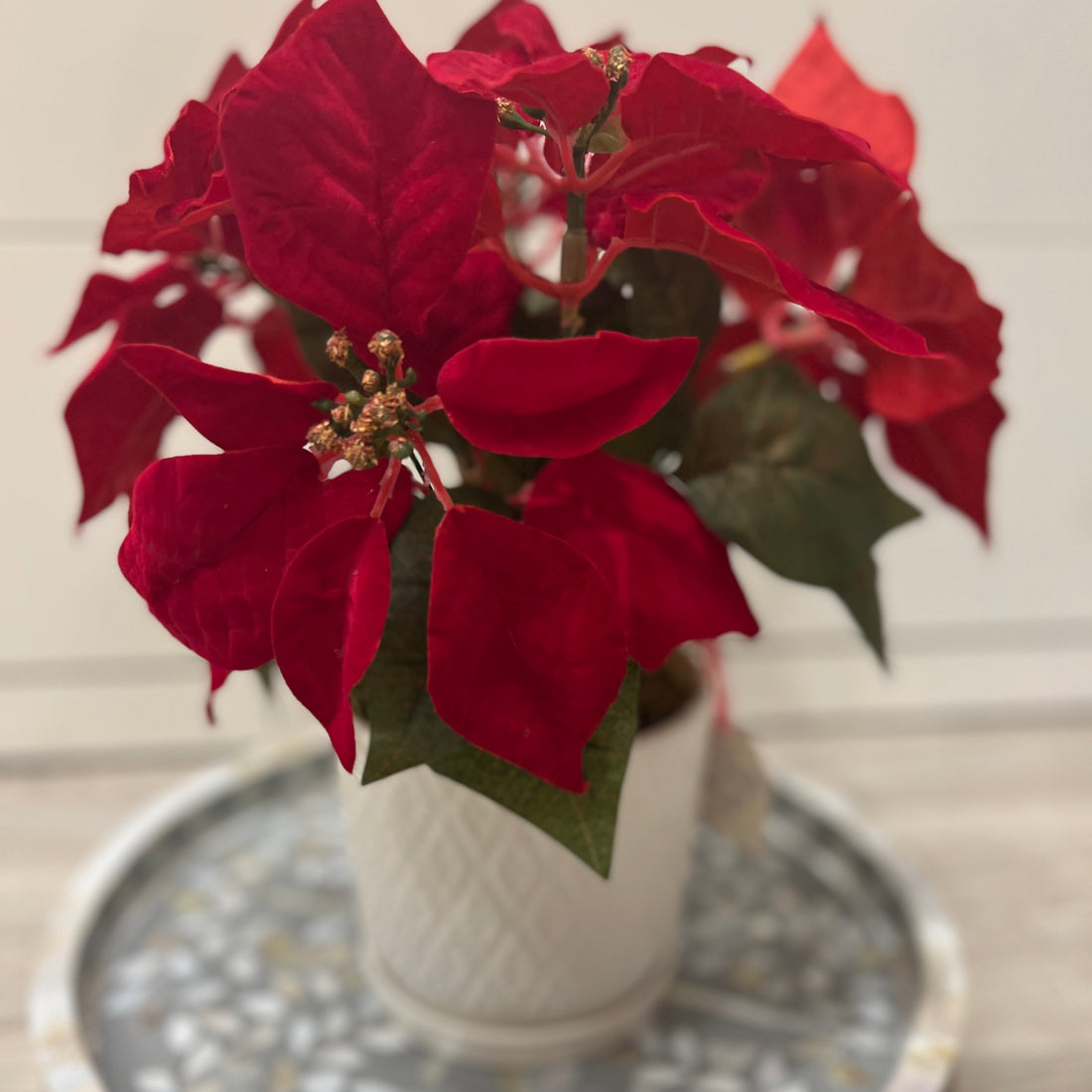 Faux poinsettia in ceramic pot